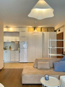 a living room with a couch and a kitchen at Cozy apartment on Sunny Beach in Sunny Beach