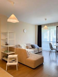 a living room with a couch and a table at Cozy apartment on Sunny Beach in Sunny Beach