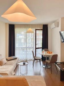 a living room with a couch and a table at Cozy apartment on Sunny Beach in Sunny Beach +24 photos