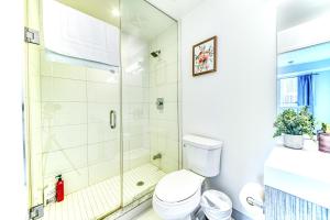 a bathroom with a shower and a toilet at RivetStays - The Jarvis in Toronto