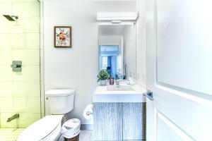 a bathroom with a sink and a toilet at RivetStays - The Jarvis in Toronto