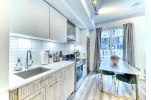 a kitchen with a sink and a counter top at RivetStays - The Jarvis in Toronto