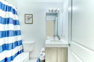 a bathroom with a toilet and a sink at RivetStays - The Jarvis in Toronto