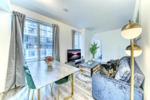 a living room with a table and a couch at RivetStays - The Jarvis in Toronto