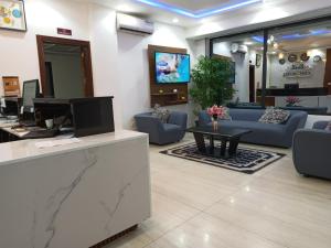 a lobby with a living room with a couch and a table at COFE Hotel in Yaoundé