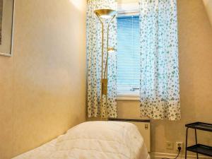 a bedroom with a bed and a window with curtains at 5 person holiday home in LYSEKIL in Lysekil