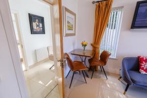 a living room with a table and a blue chair at Clanrye House Guest Accommodation in Newry