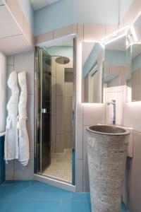 a bathroom with a glass shower and a sink at Antiqua Domus in Rome +50 photos