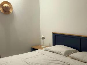 a bed with a blue headboard in a bedroom at Island house MARTA in Koločep