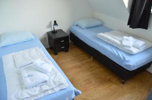 Кровать или кровати в номере Wijnberg Appartementen