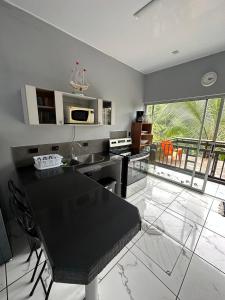 a kitchen with a black counter top in a room at Punta Leona Beach Condos in Jacó