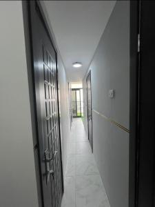 a hallway with a row of doors and a walkway at sara apartment in Dubai