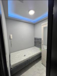 a small room with a bed in a bathroom at sara apartment in Dubai