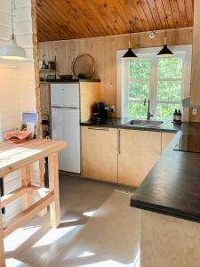 a kitchen with a sink and a counter top at Fine Details In Forest Setting In Ebeltoft in Ebeltoft