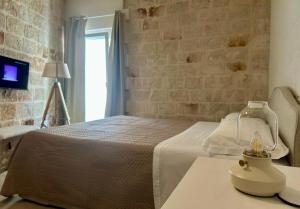 Posteľ alebo postele v izbe v ubytovaní Albergo Diffuso Monopoli