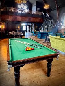 a pool table with balls on it in a room at The Old Church Isle of Bute in Port Bannatyne