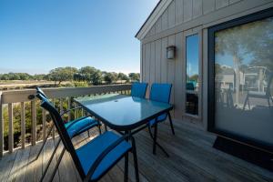 a table and chairs on the deck of a house at 815 Treeloft Cottage in Seabrook Island