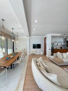 a living room with a table and a couch at Casa dei Pini Blu in Golem