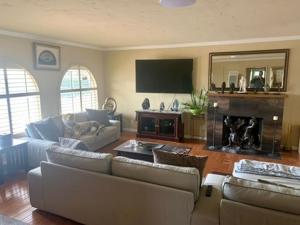 a living room with two couches and a fireplace at Room in Bay Park, San Diego in San Diego