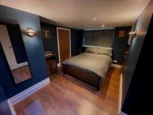 a small bedroom with a bed and a mirror at Luxurious Private Retreat Ideal Getaway for two in East Grinstead