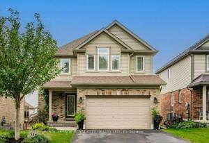 a large house with a garage at Compact,1BR Guesthouse Studio in Guelph