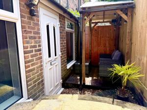 an entrance to a brick building with a wooden door at Luxurious Private Retreat Ideal Getaway for two in East Grinstead