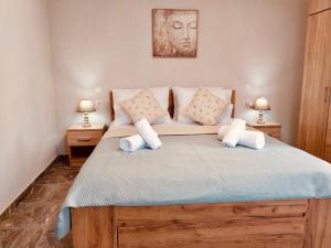 a bedroom with a large bed with two lamps at Aggelikas Guest House in Trikeri