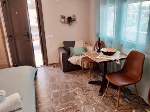 a living room with a table and a couch at Aggelikas Guest House in Trikeri +13 photos