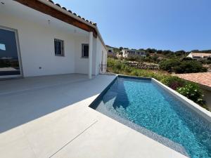 a swimming pool in the backyard of a house at Calvi - A Casa di u Mare in Calvi