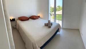 a bedroom with a bed with a teddy bear on it at Calvi - A Casa di u Mare in Calvi +10 photos