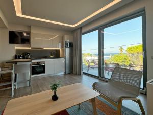 a kitchen and living room with a view of the ocean at Artemis Blue in Artemida