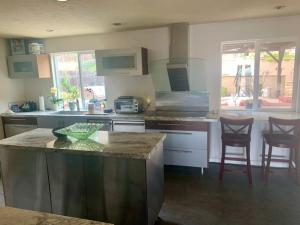 a kitchen with a counter and two chairs in it at Room in Bay Park, San Diego in San Diego
