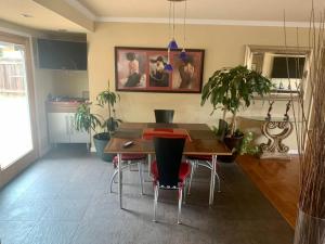 a dining room with a table and some plants at Room in Bay Park, San Diego in San Diego