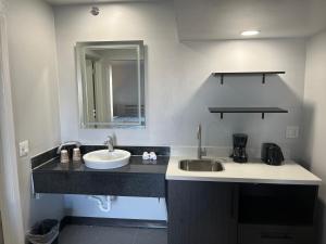 a bathroom with a sink and a mirror at Studio 6 Dumas, TX in Dumas +16 photos