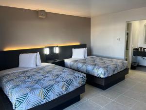 a hotel room with two beds in a room at Studio 6 Dumas, TX in Dumas