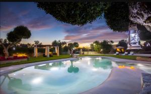 a swimming pool in a backyard at night at Tenuta degli Ulivi Salento Relax in Rocca Nuova