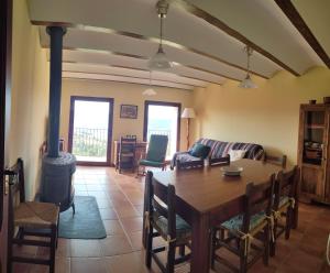 a living room with a table and a wood stove at Casa Rural María in Los Alagones +13 photos