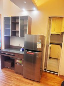 a kitchen with a stainless steel refrigerator and a counter at 暖居阁 in Hong Kong
