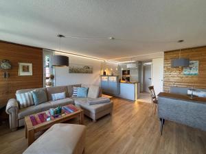 a living room with a couch and a table at Terrassenpark Apartments in Sasbachwalden