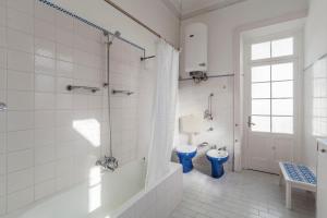 a bathroom with a tub and a toilet and a shower at Casa da Rua D'água in Ponta Delgada +21 photos