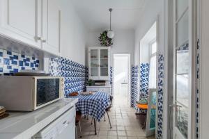 a kitchen with blue and white tiles on the walls at Casa da Rua D'água in Ponta Delgada