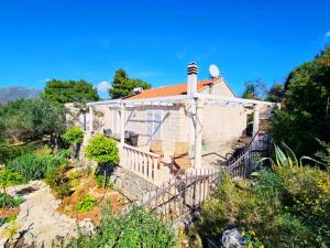 a house with a white gazebo at Island house MARTA in Koločep +9 photos