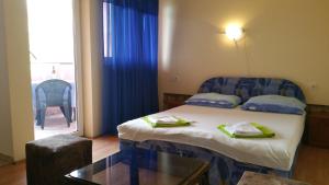 a room with a bed with a glass table and a window at B&B Pansion Zlatko in Metajna +154 photos