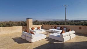 a living room with white couches and a table at Villa Nisrine Your Private Oasis With Pool and No Overlooking in Marrakech +38 photos