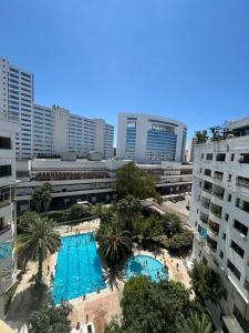 an overhead view of a pool in a city with buildings at Luxury apartment in front of the Corniche in Tangier