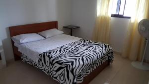a bedroom with a zebra print bed with a window at Hotel Vermon Armenia in Armenia