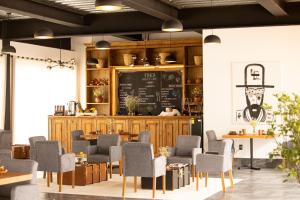 a restaurant with tables and chairs and a chalkboard at Hotel La Finca por Zotoluca in Apan +17 photos