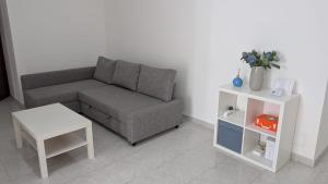 a living room with a couch and a table at Appartamento in residence "CASA DAMIA" in Taranto