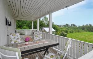 a porch with a wooden table and chairs at Villa Utsikten in Kristinehamn