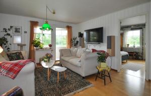 a living room with a couch and a table at Villa Utsikten in Kristinehamn